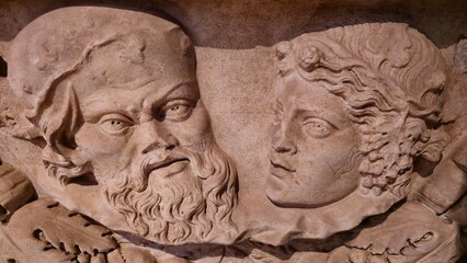 Rome, Italy - 13 January 2025. Inside the Oratory of the Forty Martyrs, a sculpted relief shows a bearded man beside a youthful figure with curled hair, both gazing slightly upward.