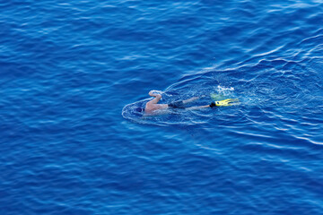 Swimming with a paddle in the sea.