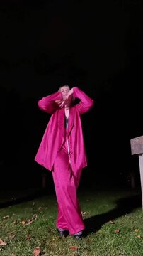 Professional dancer performing waacking at night