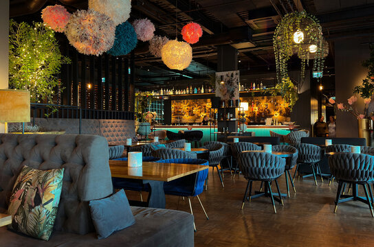 An interior photograph showcasing the chic, modern, and luxurious design of a restaurant, lounge, or high-end cafe. 