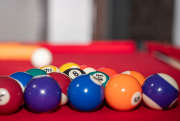 billiard balls on a red table