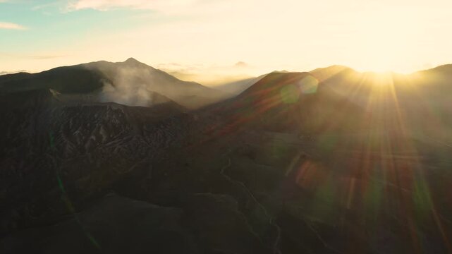 Aerial drone footage of Bromo volcano during sunrise in Bromo Tengger Semeru National Park, East Java, Indonesia.