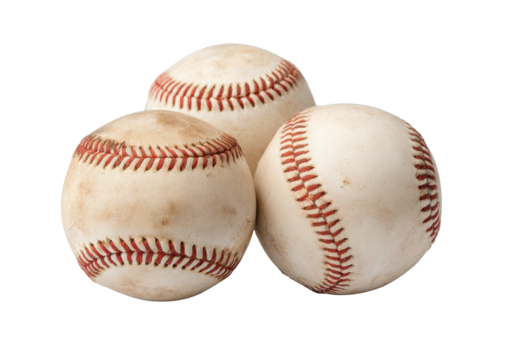 Three used baseballs piled, red seams, against black