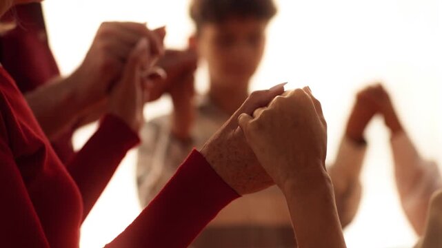 Family members gather around a table, holding hands in unity, expressing gratitude and warmth. The atmosphere is joyful as they prepare for their Thanksgiving celebration.