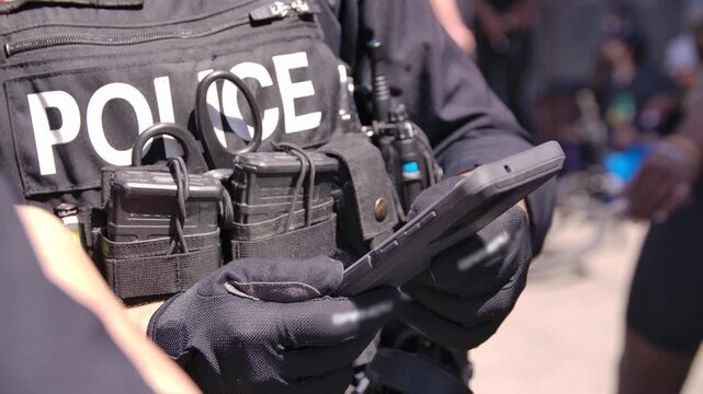 Close up police officer on tablet booking fentanyl dealer