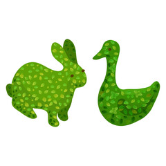 Green shrubbery sculpted into adorable bunny and duck shapes on a white background