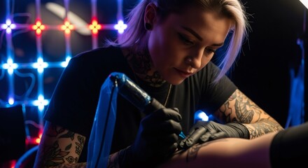 Woman tattoo artist creating a new design on hand with professional machine, focused on detail. Body art and piercing studio concept.