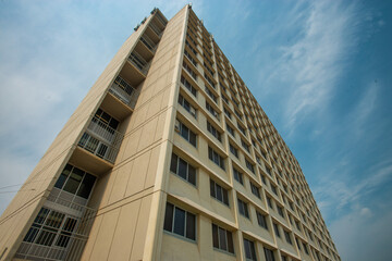 Low angle view of concrete multi story apartment  building in downtown area.
