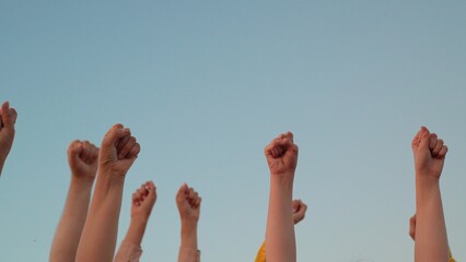 Raise your fist, expression of equality. Teamwork among businesspeople. Group of people against...