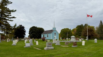 A blue church in a fall setting