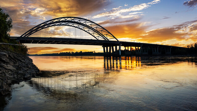 Dramatic sunrise panoramic view of the Veterans Memorial Bridge over the Missouri River at St. Charles, MO