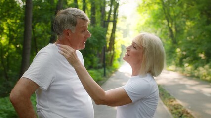 A couple in their 60s enjoys jogging together in a lush park, showcasing their active lifestyle. They share smiles and laughter, embracing fitness and companionship in nature. - Powered by Adobe