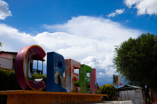 Letras coloridas del pueblo de Creel en el hermoso estado de Chihuahua, con un cielo azul y nubles blancas