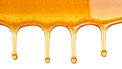 Golden honey dripping in strands and forming drops isolated on transparent background