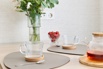 An Elegant and Beautiful Tea Set Decorated with Fresh Flowers and Juicy Berries on a Wooden Table