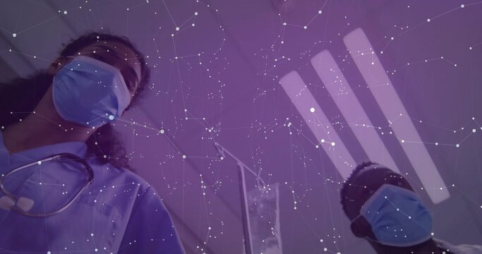 Staff in scrubs standing by IV drip in hospital ward with masks stethoscopes lights network overlay