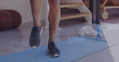 Exercising legs on light blue mat at home, with white towel, blue bottle, digital metrics overlay