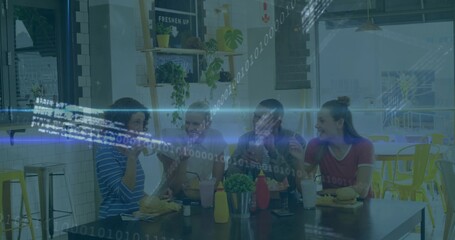 Group friends holding burgers and milkshakes while sitting around table in casual cafe, with fries