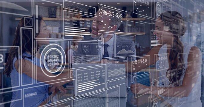 Analyzing team in business attire interpreting graphs, data in open office with transparent display - Powered by Adobe