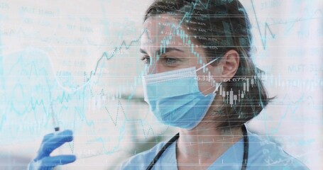 Doctor examining test vial in clinic, wearing scrubs, mask, gloves, stethoscope, charts overlay