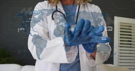 Wearing lab coat and stethoscope, doctor donning blue nitrile gloves in clinic, world map overlay