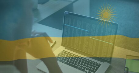 Leaning woman reading code on laptop at office cubicle desk, with smartphone, partition, copy space