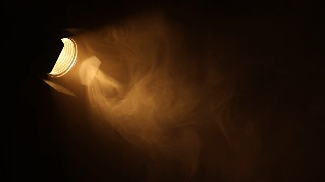Professional lighting equipment without reflector and smoke flowing on dark background