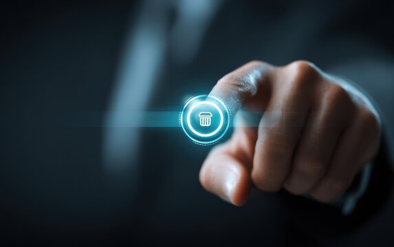Businessman touching glowing blue trash bin symbol, representing data deletion, digital cleanup, information management and cyber security concept.