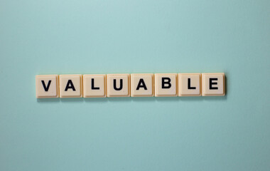 Valuable word with alphabet cubes isolated on Light Blue Background
