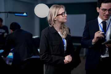 A quantum computing scientist explains a complex algorithm to a colleague, pointing to the code...