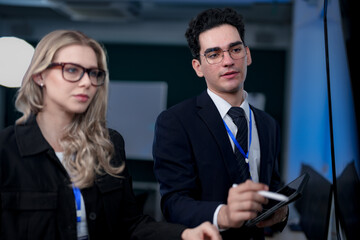 A quantum computing scientist explains a complex algorithm to a colleague, pointing to the code...