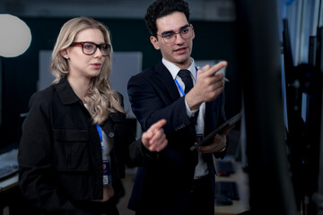 A quantum computing scientist explains a complex algorithm to a colleague, pointing to the code that will run on a quantum processor to solve a problem previously thought impossible.