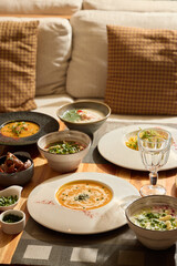 Delightful and Exquisite Gourmet Dishes Lavishly Served on a Cozy, Warm, and Inviting Table Setting
