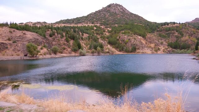 Scenic view of Afyon Erkmen Lake and surrounding mountains, camera pan from right to left in 4K