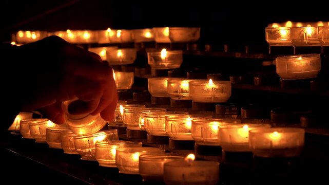 Lighting candle in church as a memory 4k