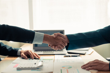 Merger and acquisition concept. Professional businessmen shaking hands after meeting and achieving results. Asian unity and teamwork concept. Team success.