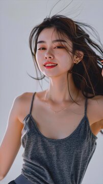 korean influencer 21 year old beautiful woman, wearing grey, tank top, dancing for social media