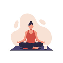 Woman meditating in lotus position on a mat with a drink nearby.