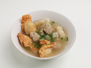 Bakso Malang or meatball soup and fried dumpling served with beef broth, in white bowl