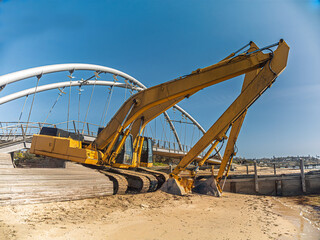 Excavators Sit On The Beach