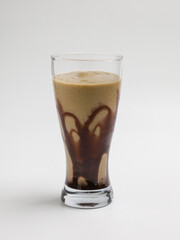 Avocado smoothies in transparent glass on white background
