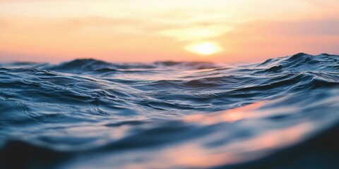 A serene ocean scene with gentle waves and a vibrant sunset in the background.