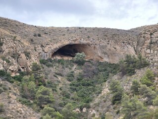 Explore the Majestic Natural Cave in the beautiful Rocky Landscape, perfect for adventurers
