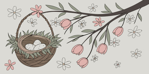 handcrafted decorative bird nest hanging in a floral spring themed arrangement on  grey backdrop.