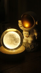 small statue or figure of a white astronaut on a dark background