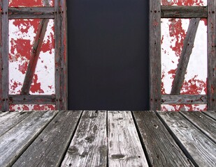 A textured black chalkboard featuring vibrant red paint splatters, creating a striking contrast that adds an artistic flair to the surface.