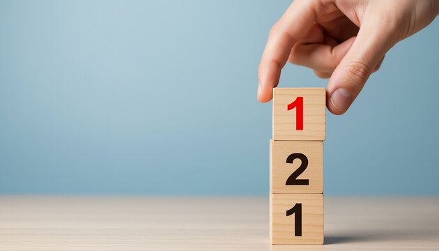 Hand stacking wooden blocks with numbers one and two concept