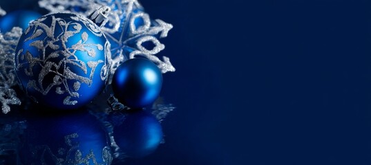 Blue Christmas Ornaments with Silver Decorations on Dark Blue Background.