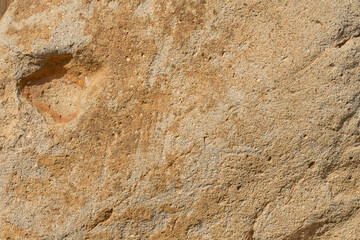 表面に凸凹のある茶色い石のクローズアップ。石や岩のテクスチャー