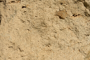 表面に凸凹のある茶色い石のクローズアップ。石や岩のテクスチャー